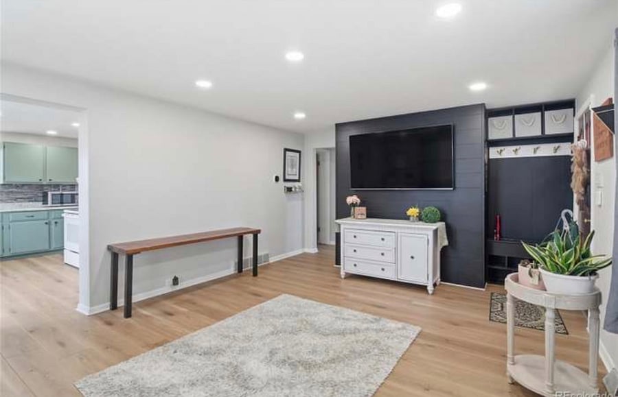 Smart TV. Entryway organization includes shoe storage, coat hooks and large storage baskets. 