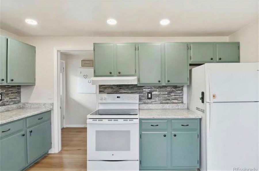 Microwave on counter under cabinets on Left. Air fryer/convection/toaster oven on counter next to fridge. Laundry room located through doorway behind stove. Stackable washer/dryer.  