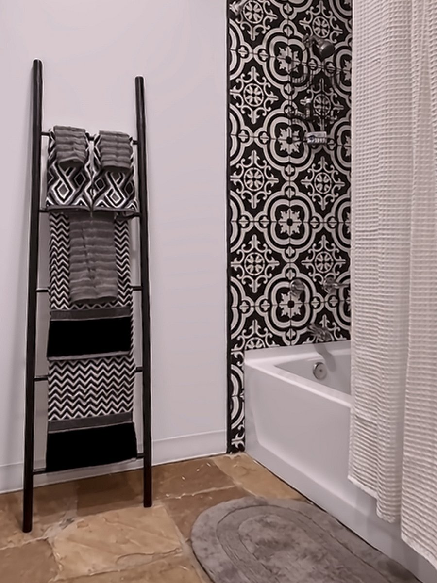 The spacious bathroom echoes the unique tile work featured in the kitchen.