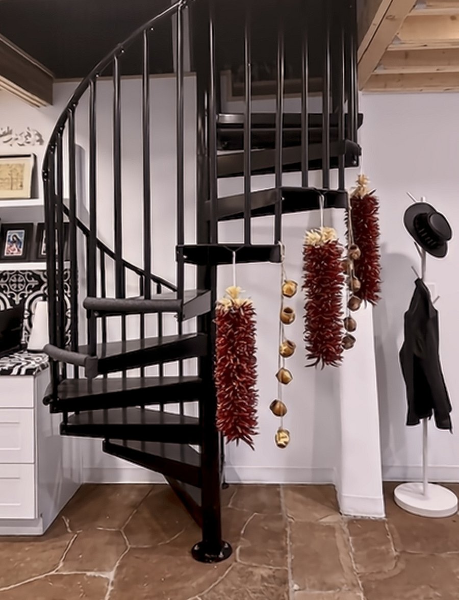 The iconic wrought iron winding staircase greets you and defines your living area.