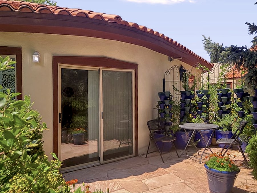 Your front sliding doors off the patio lock securely and feature light-dampening vertical blinds.