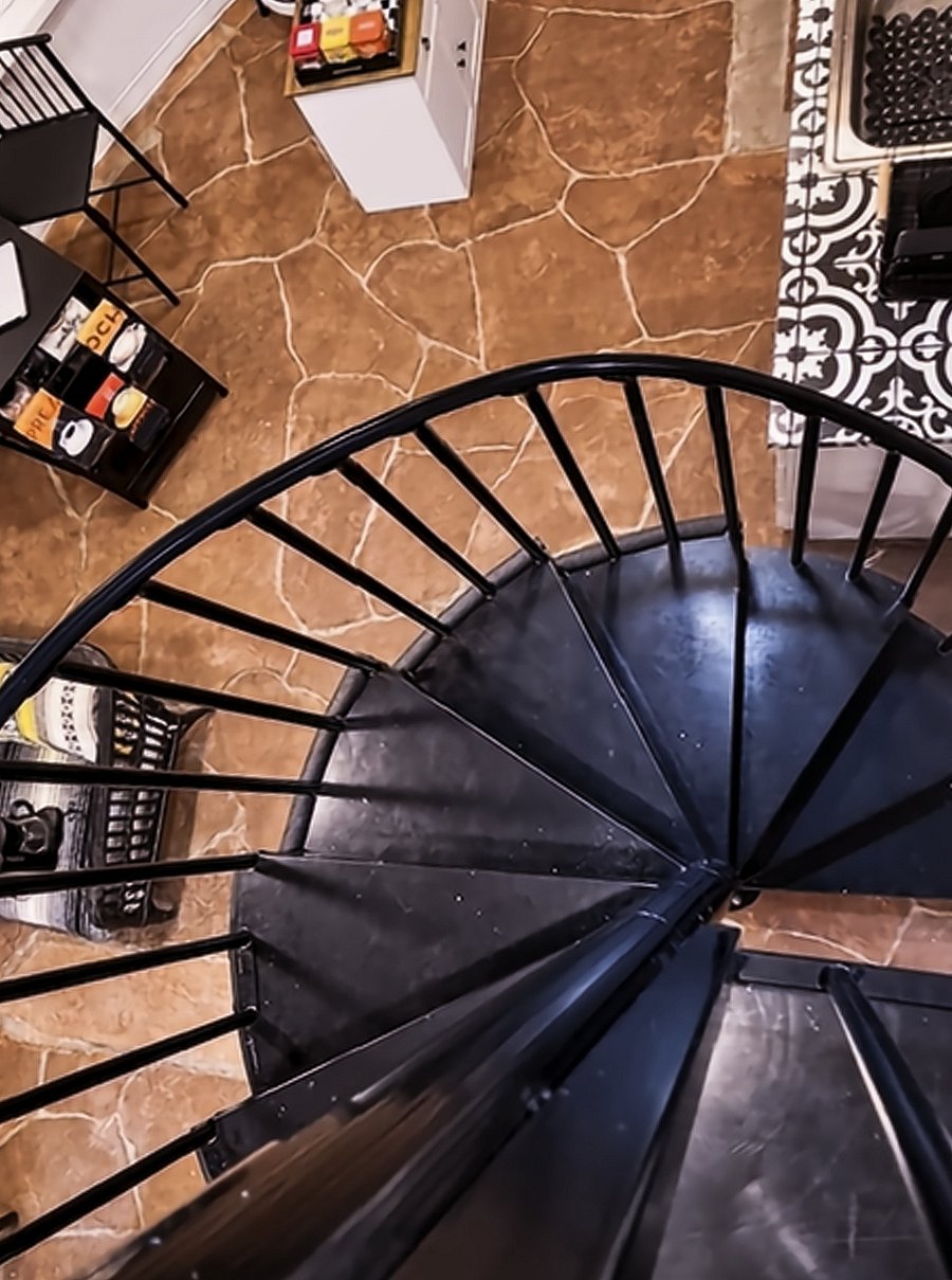 It's easy to love the graceful shape of the wrought iron as you ascend toward the loft.