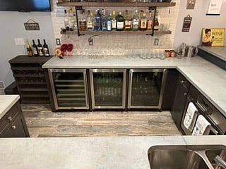 Basement bar with 2 beverage coolers and wine cooler, room temp wine storage rack