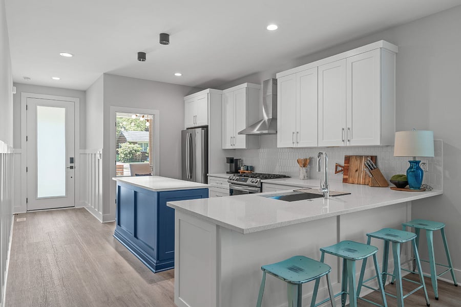 Chef's kitchen with gas range, vented hood, Keurig coffee maker, electric water kettle, knife set filtered water & filtered ice in stainless steel refrigerator. Breakfast bar for casual seating.