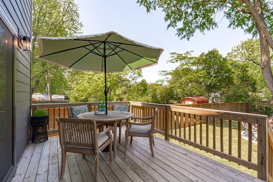 Outdoor teak dining table on raised deck. Two other sitting chairs (not shown) to comfortable sit 6 guests total.