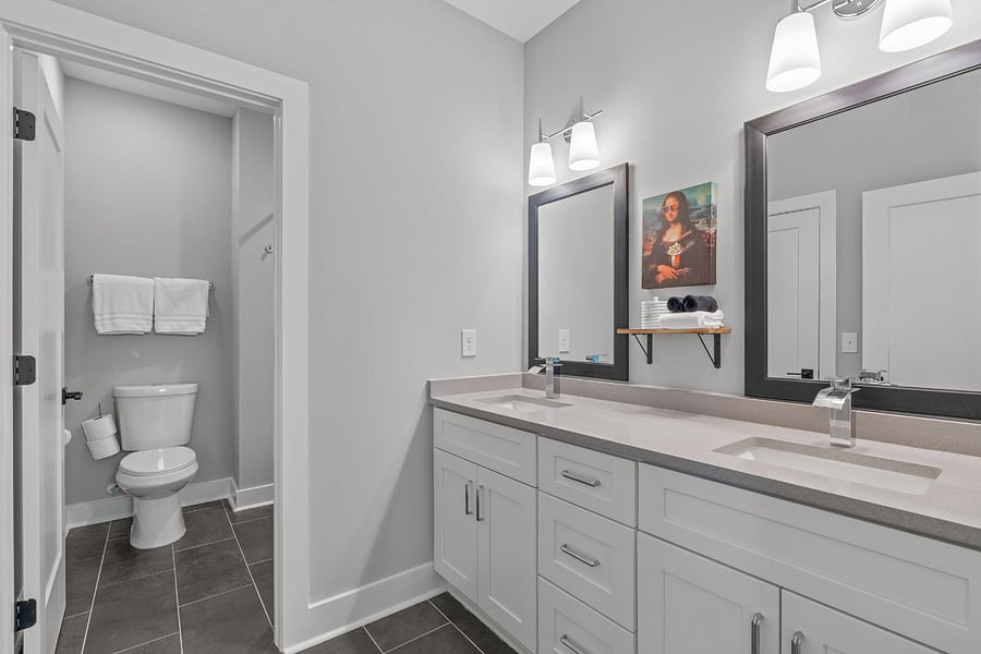 Secondary bathroom offers a dual vanity with quartz countertops and added privacy with separate dedicated shower/bath/toilet room.