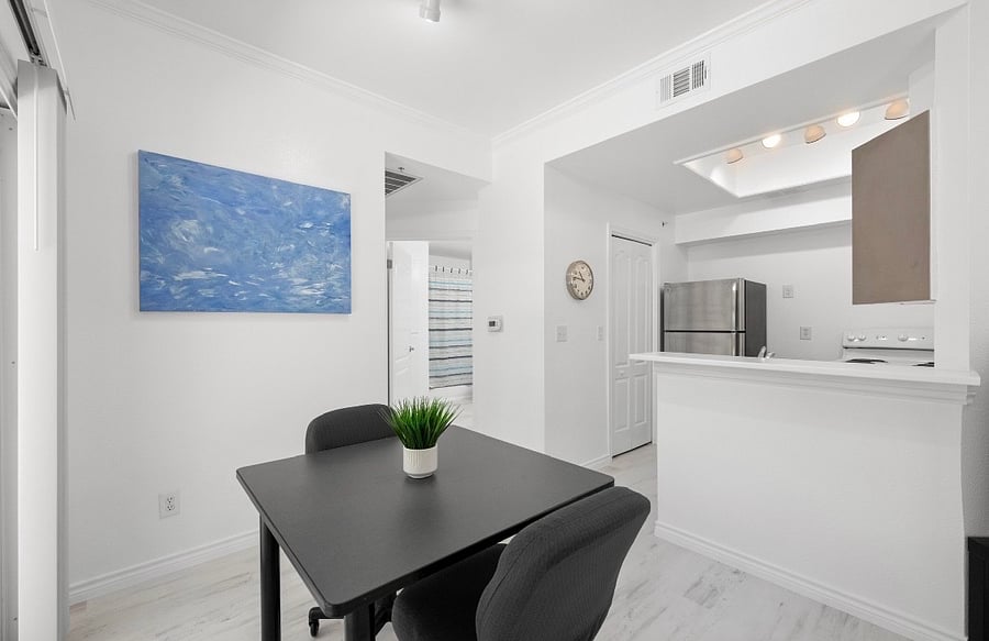 Dining room looks out onto green area/patio
