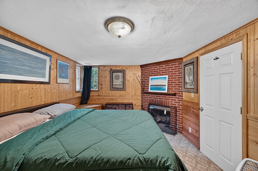 Coziest bedroom around. Fireplace and birdseye knotty pine accents. 