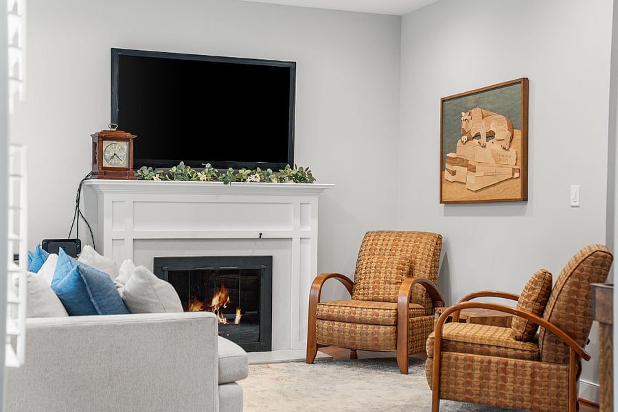 The living room with a glass fireplace could flex as a home office.