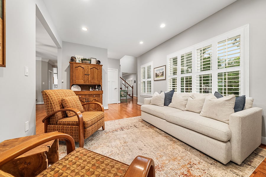The living room with a glass fireplace could flex as a home office.
