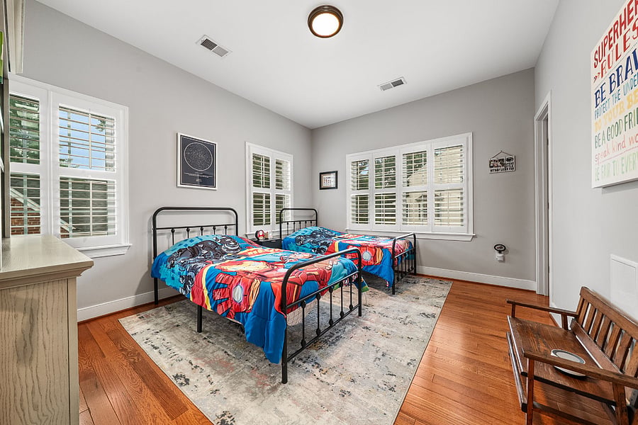 The third bedroom features two twin beds, a walk-in closet, and plenty of sunshine.