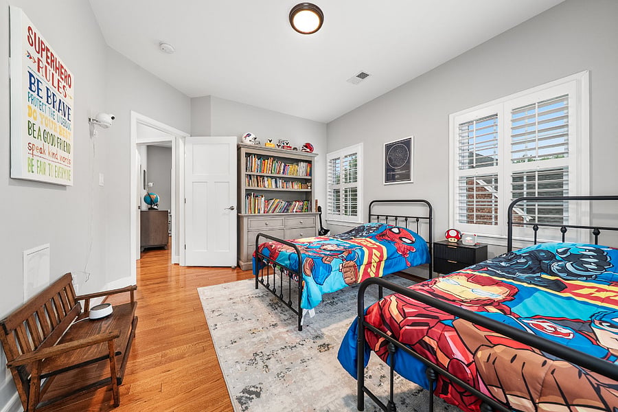 The third bedroom features two twin beds, a walk-in closet, and plenty of sunshine.