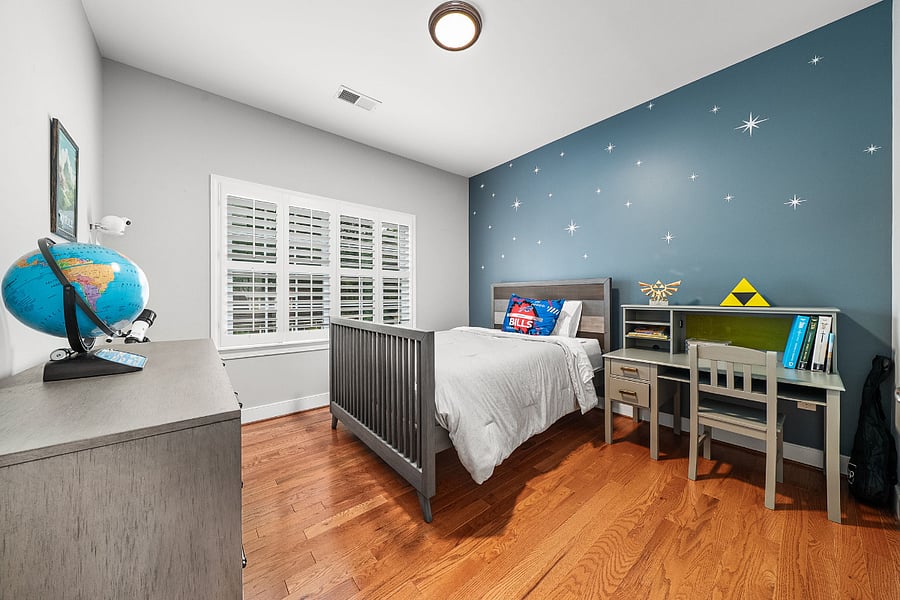 The fourth bedroom features a full-sized bed and closet.
