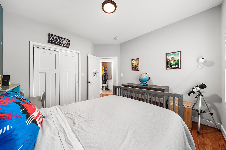 The fourth bedroom features a full-sized bed and closet.