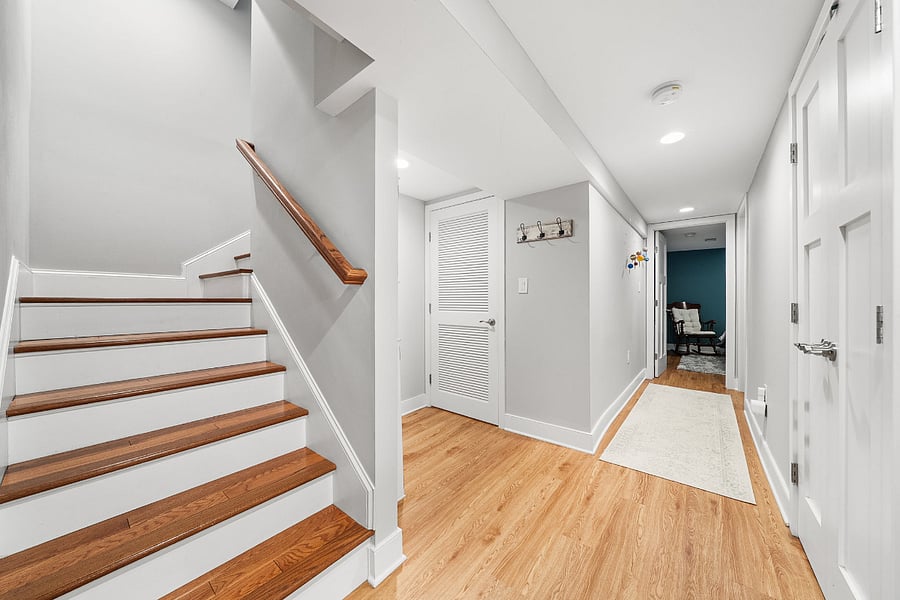 The walkout lower-level features luxury vinyl plank flooring and offers incredible flexibility with a massive recreation room, a legal fifth bedroom, a bonus room, and a full bath.