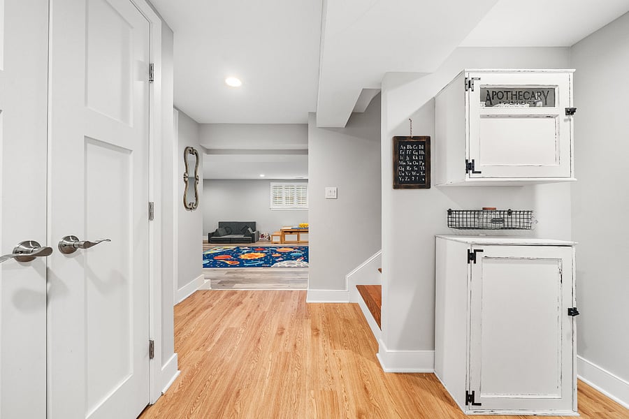 The walkout lower-level features luxury vinyl plank flooring and offers incredible flexibility with a massive recreation room, a legal fifth bedroom, a bonus room, and a full bath.
