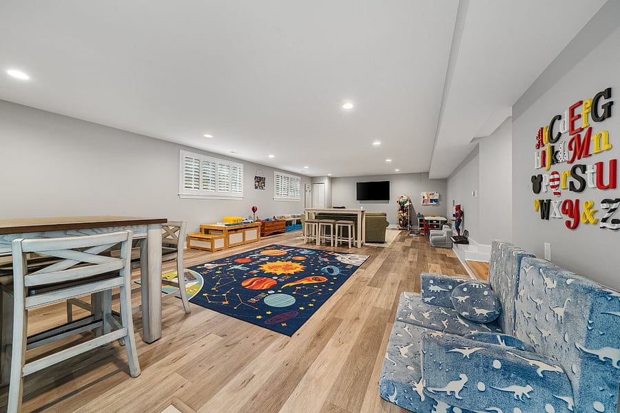 The walkout lower-level features luxury vinyl plank flooring and offers incredible flexibility with a massive recreation room, a legal fifth bedroom, a bonus room, and a full bath.