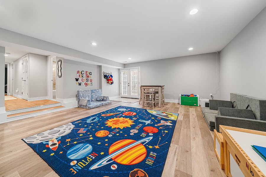 The walkout lower-level features luxury vinyl plank flooring and offers incredible flexibility with a massive recreation room, a legal fifth bedroom, a bonus room, and a full bath.