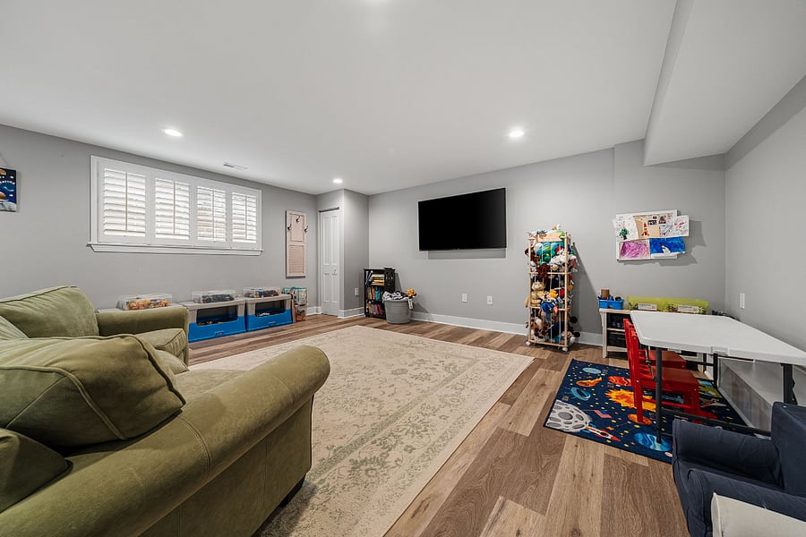 The walkout lower-level features luxury vinyl plank flooring and offers incredible flexibility with a massive recreation room, a legal fifth bedroom, a bonus room, and a full bath.