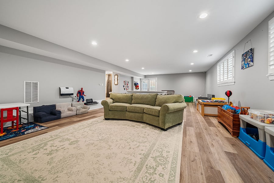 The walkout lower-level features luxury vinyl plank flooring and offers incredible flexibility with a massive recreation room, a legal fifth bedroom, a bonus room, and a full bath.