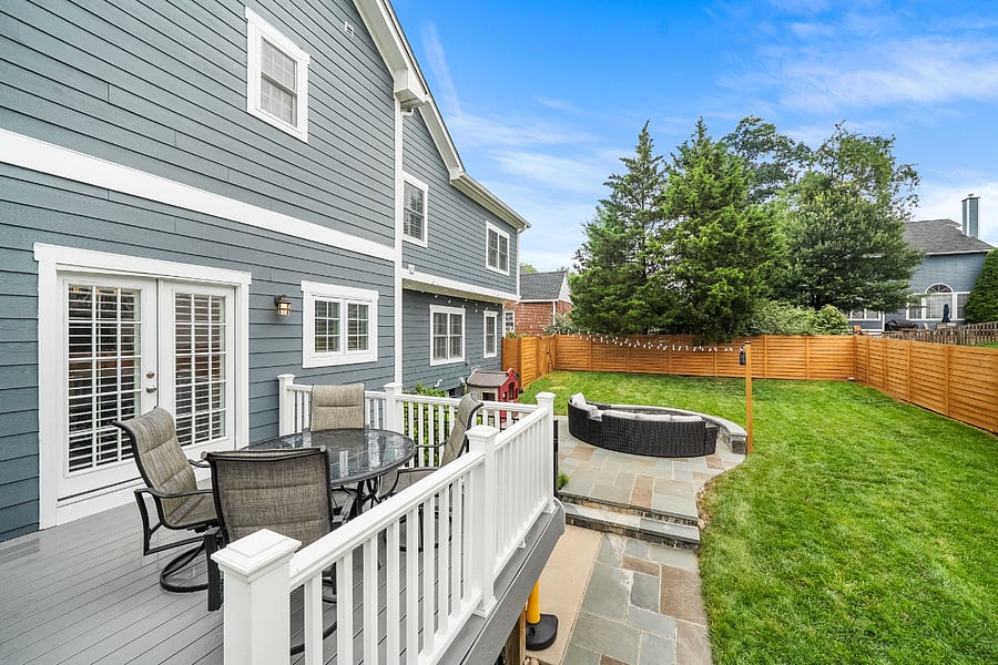 French doors off the kitchen open to a low-maintenance Trex deck overlooking a spectacular, fully reimagined backyard. Enclosed by a premium horizontal white cedar privacy fence, freshly stained in July 2026, the outdoor space features a gorgeous flagstone patio with a built-in sitting wall, tailored landscaping, and plenty of room for entertaining or relaxing outdoors.