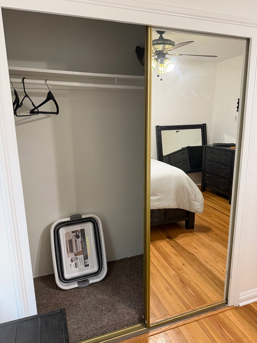 Spacious closet with mirror sliding doors 