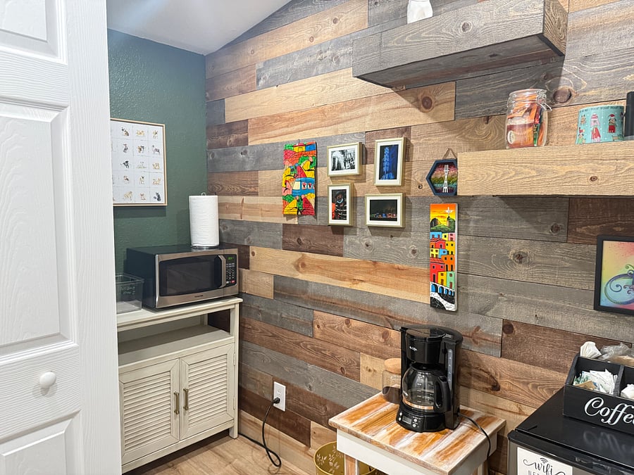 Kitchenette with microwave, coffee maker, and small fridge.
