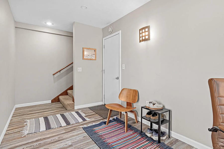Office (ground level) with service door to garage and stairs to second level.
