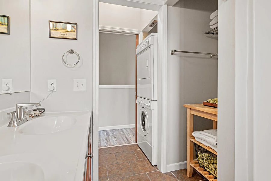 Full bath with double vanities and in-unit, full sized washer and dryer