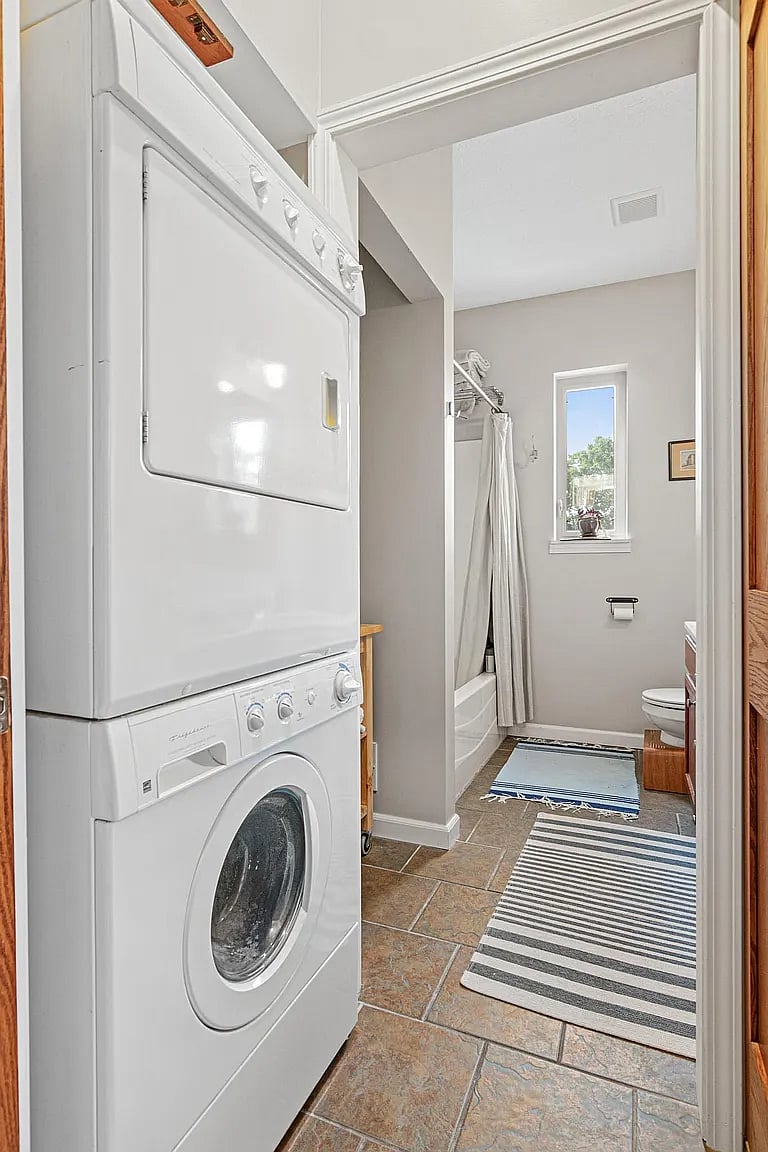 Full bath with double vanities and in-unit, full sized washer and dryer