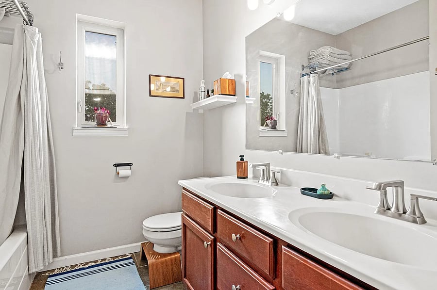 Full bath with double vanities and in-unit, full sized washer and dryer