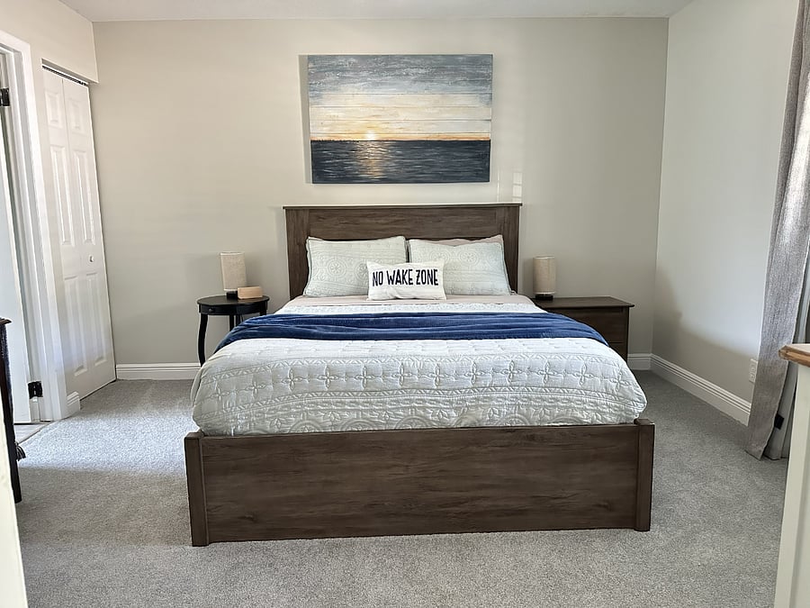 The downstairs bedroom includes a queen bed and a private entrance to the bathroom.