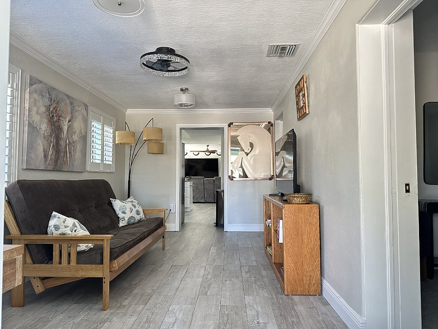 The den features a full-size futon, a TV, a desk , and a selection of fun games!