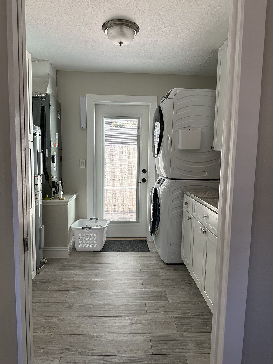 Adjacent to the kitchen, you'll find ample storage space along with a full-sized washer and dryer for your convenience.