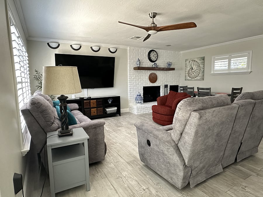 The spacious living room offers ample seating and a massive 83" TV, perfect for an immersive cinematic experience!