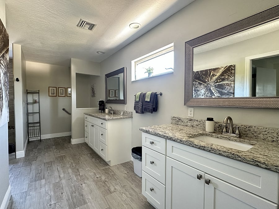 The expansive upstairs bathroom features dual vanities and a spacious walk-in shower.