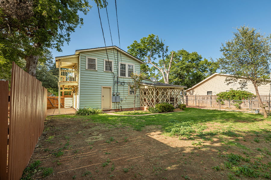 Backyard with entrance to shared laundry room