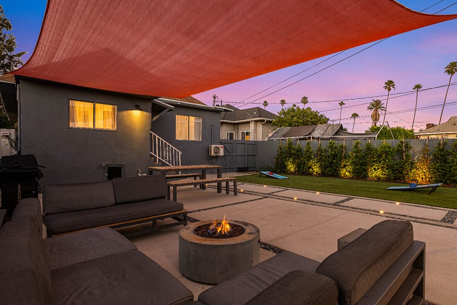 Backyard patio and dining furniture with fire pit.