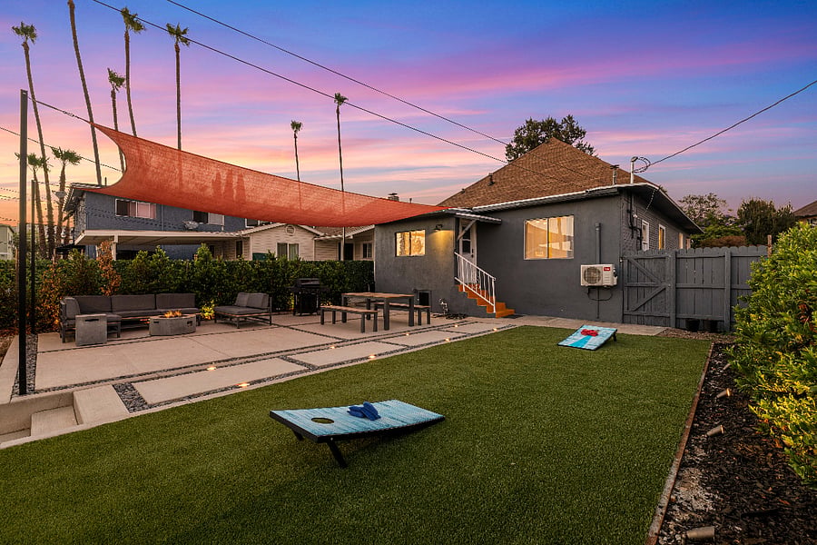 Covered, outdoor entertainment area and rear entrance to house