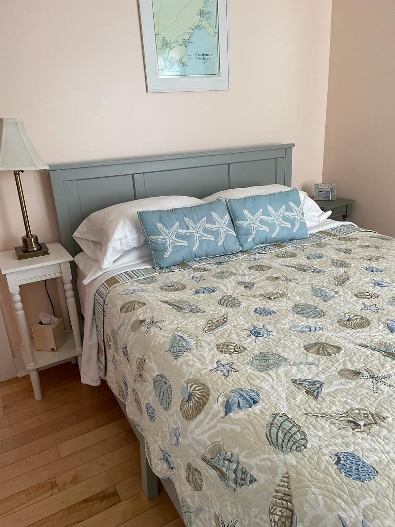 Bedroom with queen bed & TV on dresser, built-in closet