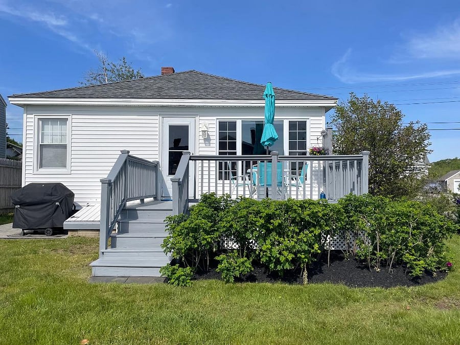 Back of cottage with deck & gas grill