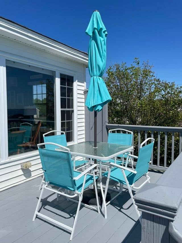 Outdoor deck with table, chairs, & umbrella for outdoor dining