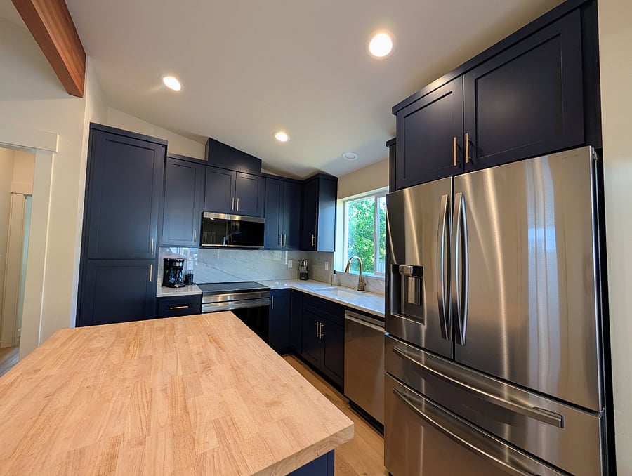 Large stainless refrigerator with center drawer, ice and water on the door