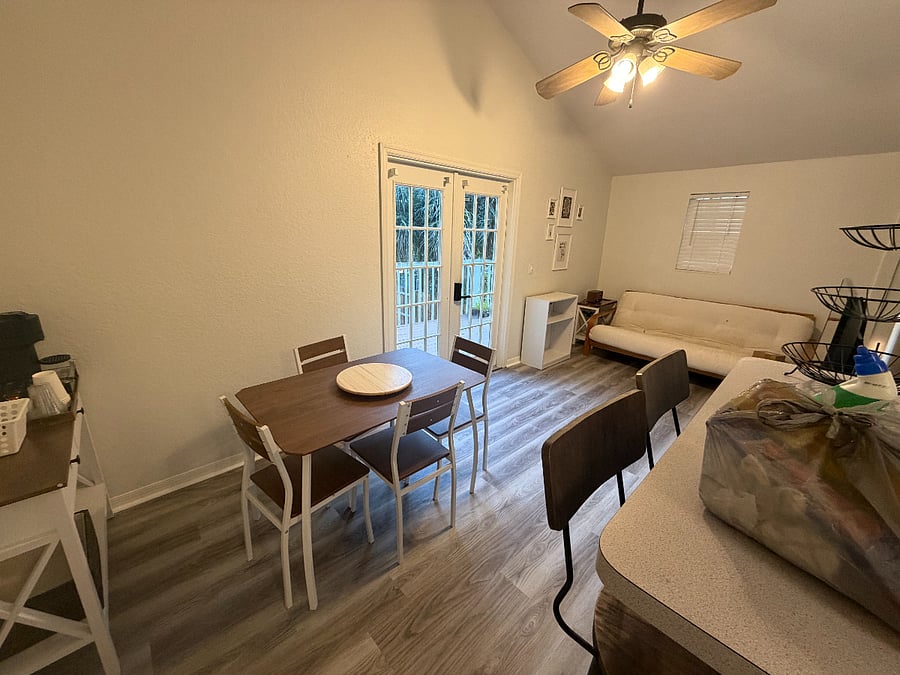 Living area with futon and book case with 43" Smart TV. Futon Cover is sanitized and steam cleaned after each visit. This is the Second Floor.