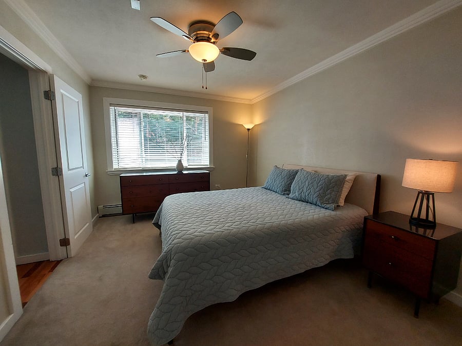 Comfortable bedroom with dresser, nightstands and closet storage
