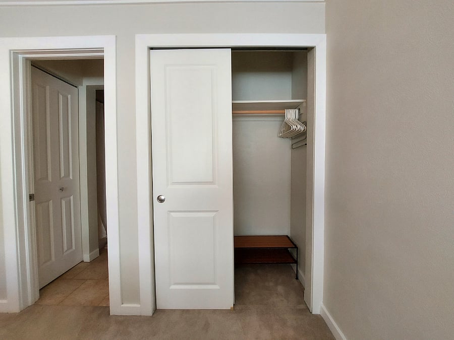Full closet with hanging and shoe storage