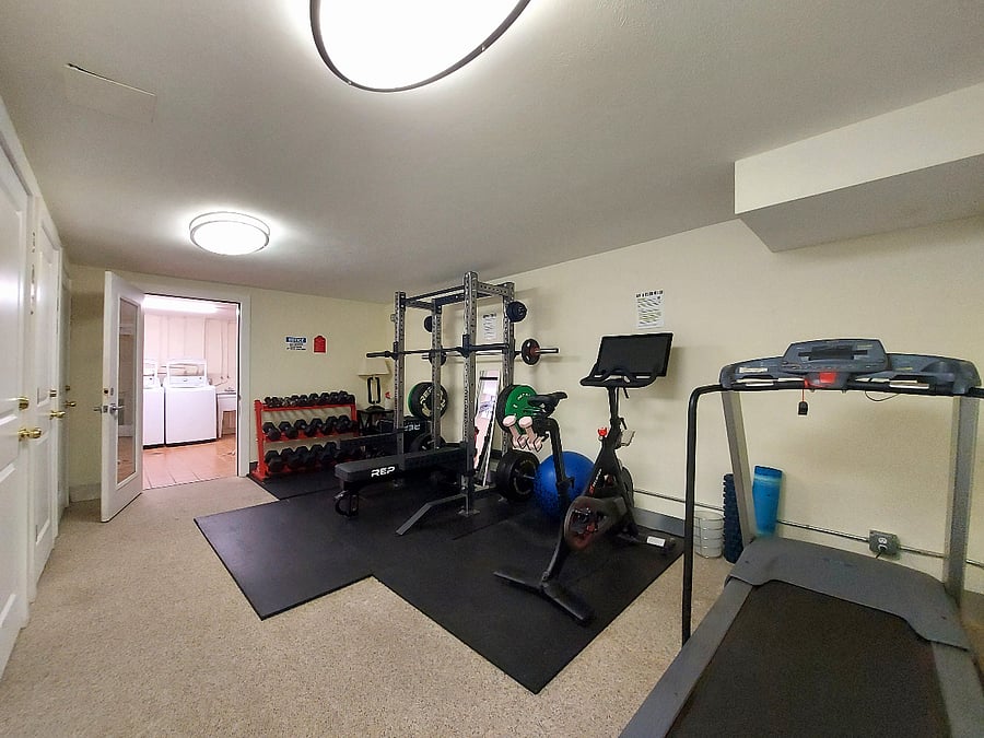 Resident fitness room with Peloton bike, treadmill, power rack, bench, REP dumbbells and plyo box