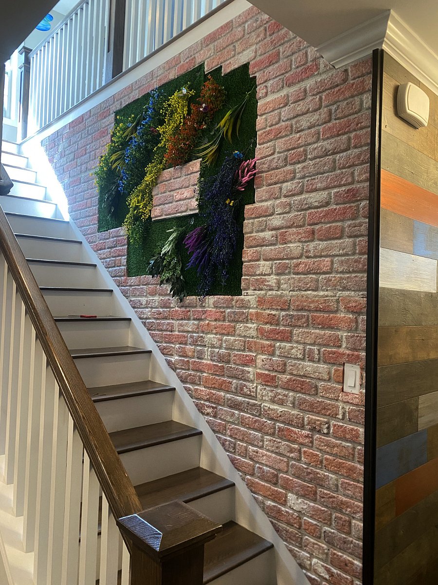 Stairs leading to all three bedrooms upstairs. As you can see, we like to add interesting deco to most of the available wall space. In this case, we added a faux brick wall which has insert of grass and flowers.
