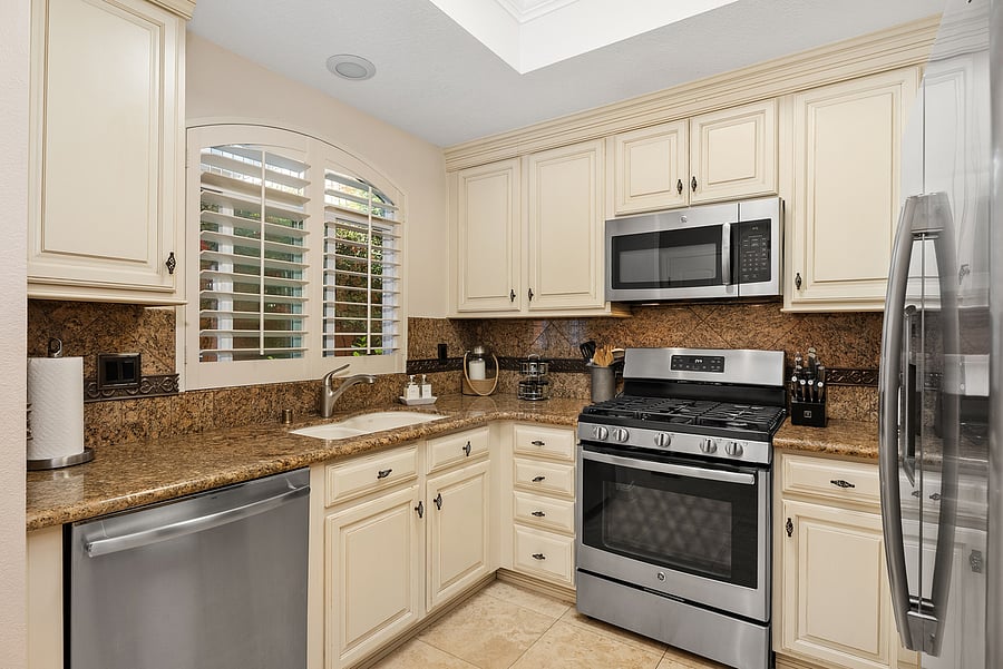 Kemper cabinets, granite counter tops and stainless steel GE appliances and pantry with slide out shelves.