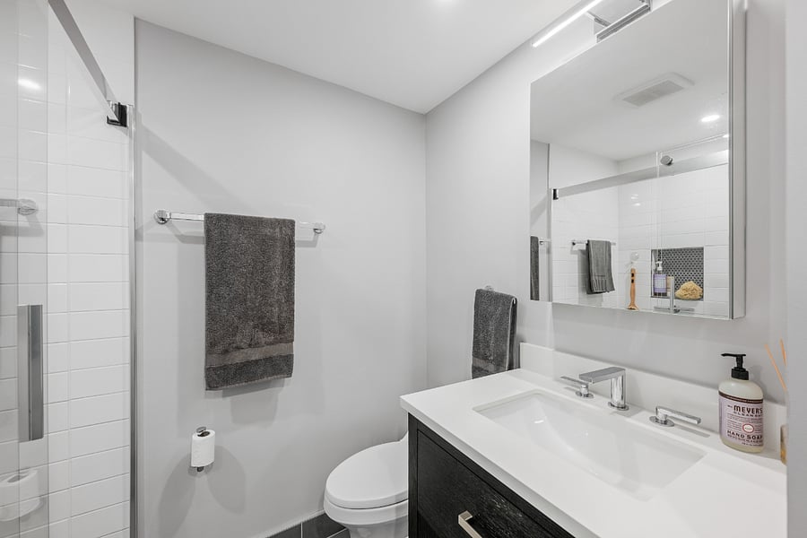 Renovated bath with generous vanity and storage.